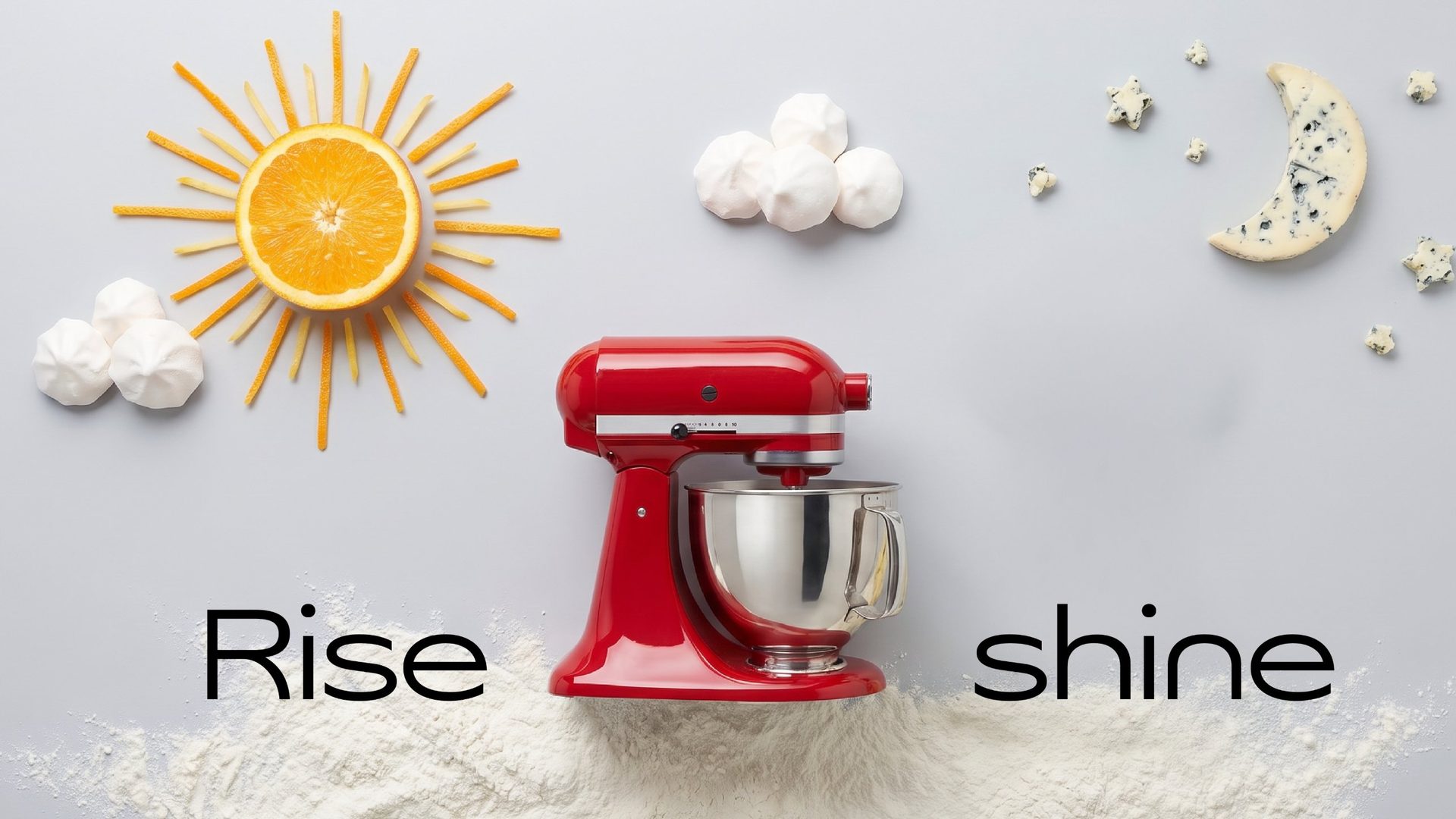 Rise and shine: a red stand mixer between an orange sun and a cheese moon