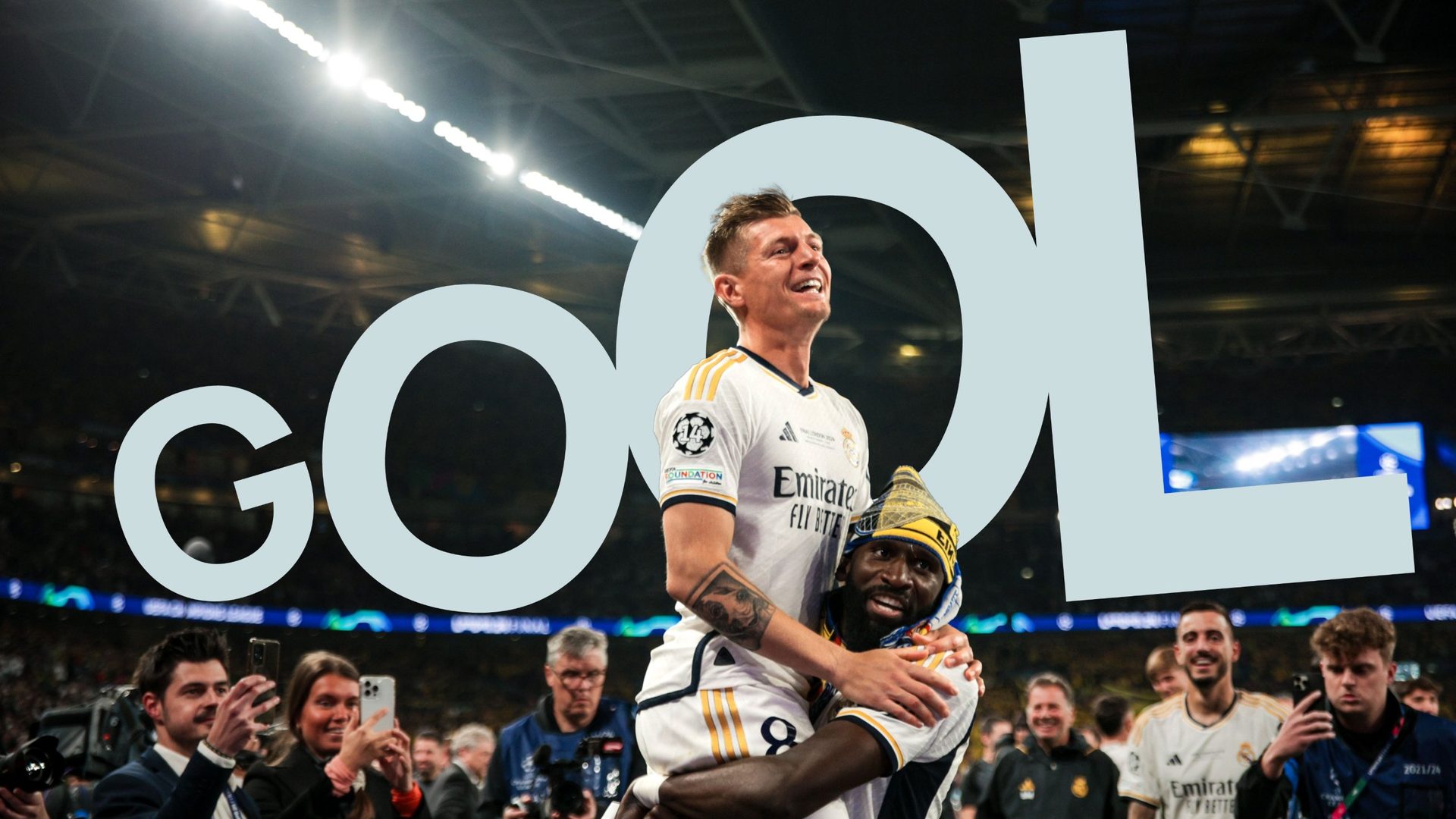 Real Madrid players celebrating behind the word Gool