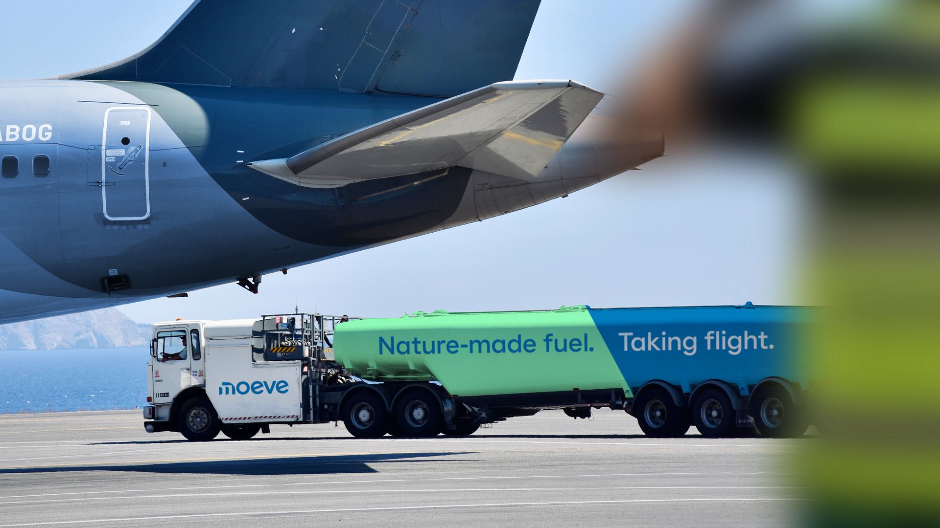 Moeve fuel truck by a plane: Nature-made fuel. Taking flight.